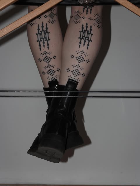 Healed ornamental tattoos on both shins by Zuzana Mala